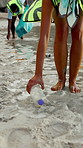 People, legs and beach with bag for recycling, cleaning dirt or pollution on sandy shore. Group, volunteer or rubbish with plastic bottles on ocean coast for community service or earth day together