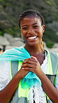 Clean up, black woman and face of volunteer on beach for community, service or sustainability program. Happy, bag and portrait of NGO worker with social responsibility for waste management by ocean.