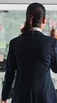 Glass wall, sticky note and back of businesswoman in office with planning for finance report with budget. Thinking, board and financial manager with research for investment proposal in workplace.