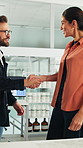 Happy, woman and handshake with investor in office, success or agreement for wind turbine investment. People, shaking hands and funding for renewable energy, sustainability or smile for collaboration