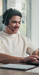 Man, headset and typing with laptop at office for trading, contact us and smile at finance agency. Person, virtual consultant or advisor with headphones, computer and voip mic at investment company