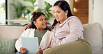 Girl, mom and relax with tablet on sofa for games, bonding or happy with movie choice in family home. Asian people, mother and daughter with tech, child or application with film subscription at house
