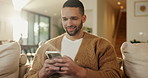 Phone, relax and happy man in home for social media, online response or check profile at living room. Mobile, sofa and person with app for communication on forum, smile or post update with message