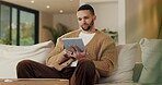 Remote work, review or copywriter on couch with tablet, proofreading or email feedback for blog draft. Reading, wfh or man in house with tech, fact check or script planning with industry research.