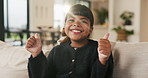 Cute, face and thumbs up with girl child on sofa in home living room for development or growth. Adorable, future and success with happy kid on couch in apartment for morning, relax or weekend chill