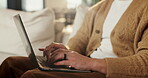 Hands, laptop and person typing on sofa in home for internet search, browsing or social media. Casual, relax and online user in living room with computer for connection, email or subscription