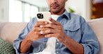 Hands, phone and relax with texting on sofa in home, contact and scroll for web chat in living room. Person, typing and click on mobile app, notification and chill with social media post at apartment