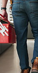 Tool box, man and plumber walking in home for maintenance, repairs or evaluation in kitchen. Equipment, industry and back of male contractor in house for appliance installation or inspection.