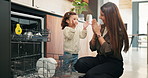 Dishwasher, clapping and mother with kid in kitchen for learning, teaching and support at home. Praise, family and woman with girl for child development, hygiene and cleaning for chores or dishes