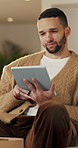 Reading, calm and man with tablet in home on weekend, digital news story or connection for web novel. Internet search, tech and person with smile for ebook app, browsing online and check blog post