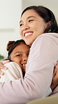 Love, mother and child with hug in home for connection, security and smile for family time together. Bonding, happy woman and daughter with embrace for childhood support, trust and care for affection