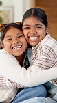 Love, face and kids hug in home for support, laugh and connection together with happy sisters. Children, siblings or girls embrace at family house with smile for trust, funny or bonding with care