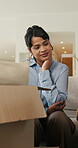 Boxes, home and woman with anxiety for eviction, think and frustrated with financial crisis and debt. Unhappy, tenant and person with depression, reflection and stress for lease termination or moving