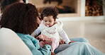 Family, siblings and baby in home with parent, bonding and big sister playing with infant. Playful, song or lullaby with girl or child in house with mother for love, together and game in relationship
