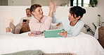 Tablet, high five and mother bonding with teen on bed for quiz game, correct answer and success. Tech, mom and boy with celebration in house for playing online puzzle, problem solving and family fun