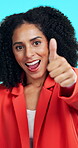 Face, woman and thumbs up with down in studio, well done sign and feedback change for negative review. Smile, upset and employee with disagreement gesture for decision, portrait and blue background