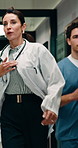Doctors, running and medical emergency in hospital for urgent healthcare or patient support. People, team and nurse in rush for crisis response, surgery or life saving treatment in hallway together