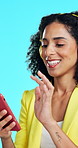 Headphones, dance and woman with phone in studio, streaming service and listening to music playlist. Happy, audio tech or employee with song on radio station, blue background or moving to rhythm