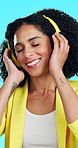 Headphones, dance and woman with smile in studio, streaming service and listening to music playlist. Happy, audio tech and person with song on radio station, blue background and moving to rhythm