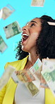 Businesswoman, surprise and money rain in studio with lottery prize winner, jackpot success and wealth. Happy, person and wow with cash shower, financial freedom and giveaway win on blue background.