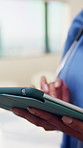 Hands, typing and nurse in clinic with tablet for research, patient diagnosis or online consulting. Medical professional, woman and digital tech in hospital for telehealth, case report for healthcare