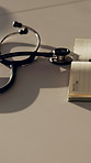 Stethoscope, notebook and desk for healthcare, medical research and hospital services or planning. Paperwork, heart equipment and information in clinic for cardiology, schedule or notes in office