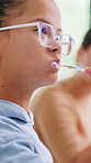Girl, child and brushing teeth in bathroom with hygiene, oral care and morning routine for wellness. Kid, cleaning mouth and toothbrush in family home with toothpaste, dental health or getting ready.