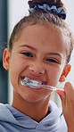 Toothpaste, dental care and face of child in bathroom for hygiene, wellness and clean mouth. Happy, oral health and portrait of girl kid brushing teeth for morning routine with fresh breath in home.