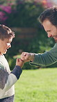 Dad, child and garden with friendly fist bump in nature for winning, good job or greeting together. Father, secret or handshake with son, kid or connection for success or outdoor bonding in park