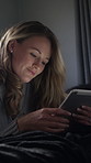 Woman, online and relax with tablet on bed, smile or scroll ebook on web with subscription at night. Happy person, home and reading novel with tech in dark bedroom, rest and entertainment on break