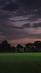 Night, empty and field with rugby pole for game, match and training for tournament or competition. Evening, stadium and background with goal post, grass and space for exercise, contest and fitness