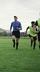 Rugby, team and coach running on field with exercise drill, fitness or practice skills for competition. Instructor, whistle and people outdoor at sports club with training, speed workout or wellness.