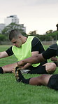 Man, sport and stretching with team for workout preparation or leadership on grass field. Active, male person or athletic captain getting ready with rugby players training for warm up, match or game