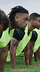 Field, rugby and men in training with push up to prepare for match, competition and tournament. Sports, team and people with coach for exercise, workout and stopwatch for warm up, game and practice