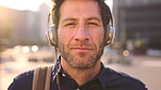 Face, businessman and travel in city with headphones, streaming podcast or thinking for job opportunity. Bokeh, person and worker commute in urban town with audio tech, music or reflection for career