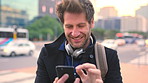 Commute, laughing or businessman in city with phone, online chat or comic post on social media. Smile, wind or employee in town with tech, funny text message or meme reaction in travel routine.