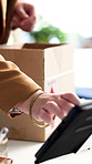Logistics, packaging and hands with tablet in small business, supply chain or update ecommerce order. Startup, entrepreneur and person with tech, stock distribution and online shop sales on website