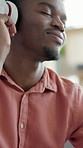 Dancing, man and happy with headphones, home and listening to music with app subscription on weekend. Streaming, audio and black person with tech, rhythm and movement with song playlist in house