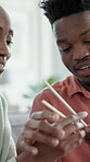 Couple, teaching and helping in home with chopsticks, technique and assistance for new skill. Smile, people and learning with sticks for dining etiquette, learning customs and bonding for tradition