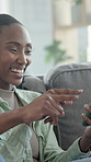 Couple, gaming and woman with phone in lounge, discussion or asking for advice with smile on weekend. Black people, home and playing video game on mobile, laughing and bonding with partner on sofa