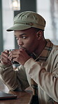 Laptop, man and thinking with coffee in cafe for story ideas, editing break and remote work. Copywriter, black person or beverage with tech at diner window for blog inspiration, insight or freelancer
