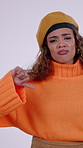 Thumbs down, fashion and face of woman in studio with bad news, disagreement or disappointment. Unhappy, outfit and portrait of female person with negative hand gesture for style by white background.