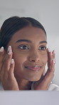 Beauty, woman and check skin in mirror for foundation coverage, cosmetic glow and hydration. Reflection, person and happy with routine inspection in home for makeup results, self care and cosmetology