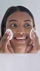 Woman, skincare and cotton pad in bathroom with makeup removal, hygiene and face cleaning in home. Cosmetics, skin toner and smile with dermatology for antiaging, self care and beauty treatment