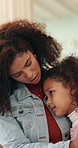 Mom, girl and hug with comfort in home for love, empathy or emotional connection together. Mother, daughter or embrace with child, safety or protection on sofa for gentle parenting or development