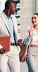 Travel, walking and business people in city talking for planning, project update and finance team. Corporate, town and woman with man in discussion, conversation and meeting for proposal feedback