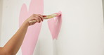Hands, heart and person with paint on wall for nursery, expectation and love with home decor. Icon, brush and shape for romantic gesture, style and symbol with mural art, fun activity and hobby
