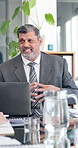 Laptop, documents and businessman in office for meeting with finance report for revenue planning. Computer, discussion and mature financial manager with paperwork for investment proposal in workplace
