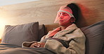 Red light, cosmetic and woman with mask for skincare, relax or wellness with collagen production. Health, beauty and female person on bed with LED phototherapy for dermatology treatment in home.