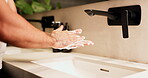 Sink, soap, washing hands with man in bathroom of home for disinfection or hygiene. Basin, cleaning and foam with person in apartment to remove bacteria or germs for morning self care routine